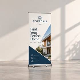 Retractable roll-up banner stand with a real estate graphic