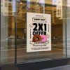 Removable window cling featuring a bakery shop promotional design