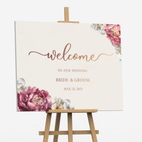 Custom wedding welcome sign printed on foam board with pink floral artwork displayed on a wooden easel