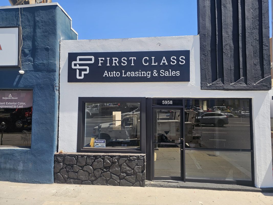Professional business sign for auto leasing and sales installed on a building facade
