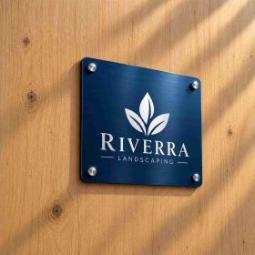 Custom metal sign with logo mounted on a wooden wall