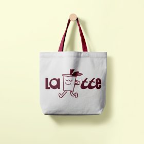 White tote bag with burgundy handles and a coffee cup logo hanging from a wall hook.