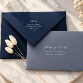 Navy and blue envelopes with printed white address and return address