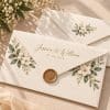Cream printed envelopes with floral design and gold wax seal