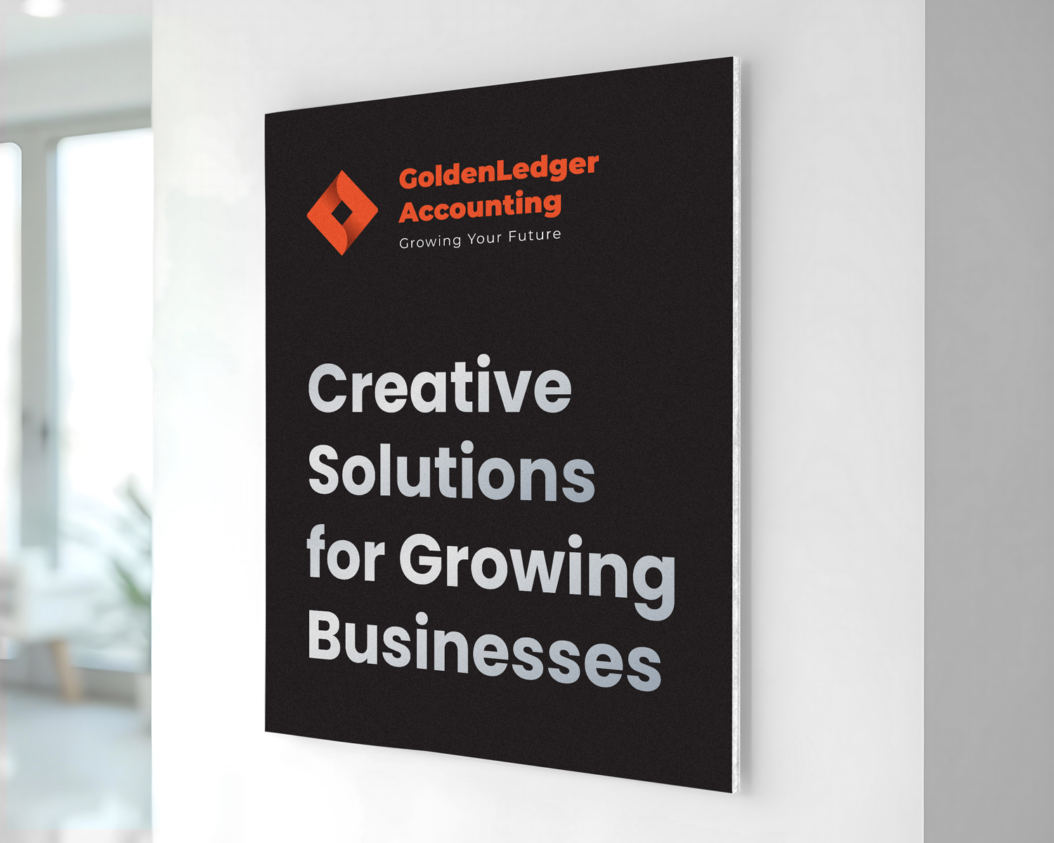 Black and orange foam board sign with business branding mounted on an indoor wall.