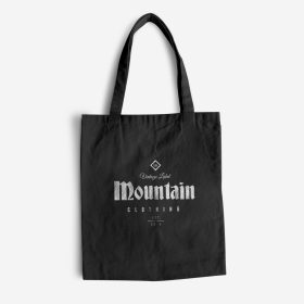 Black tote bag with white mountain artwork.