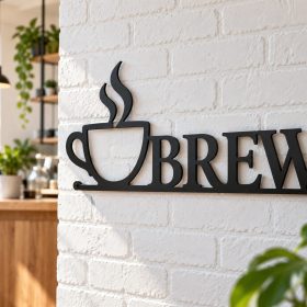 Black laser cut steel café sign with coffee cup and BREW lettering mounted on a white brick wall