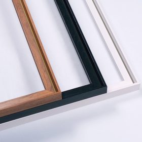 Three framed canvas prints side by side in pecan, black and white floating frames