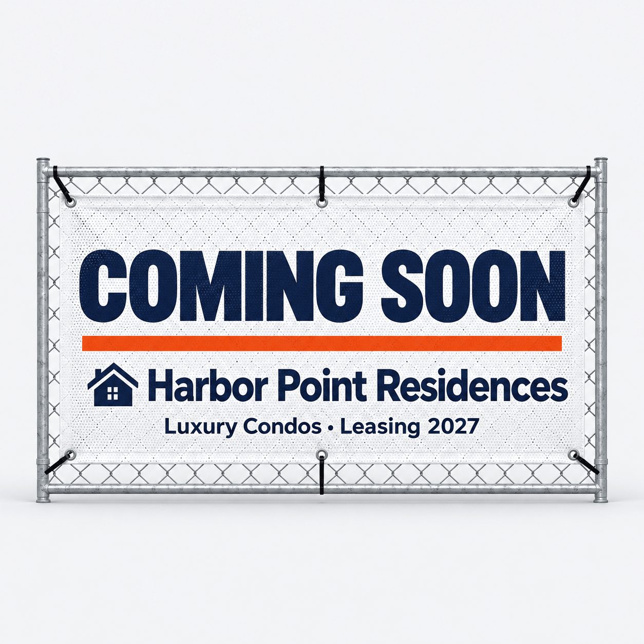 White mesh fence banner reading Coming Soon zip-tied to a chain-link construction fence