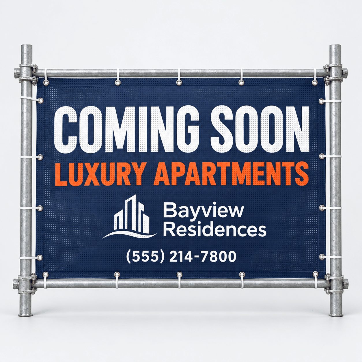 Navy mesh scaffolding banner reading Coming Soon Luxury Apartments zip-tied to a scaffolding frame