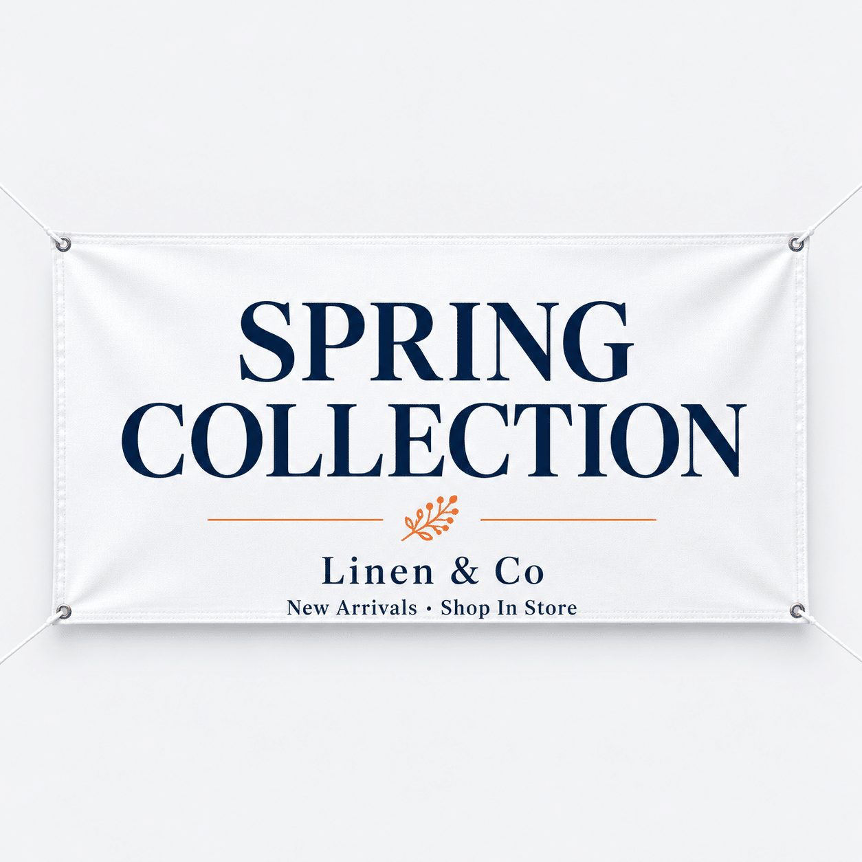 White fabric banner with navy text reading Spring Collection for a boutique