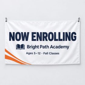 White smooth indoor PVC banner reading Now Enrolling hung on a wall