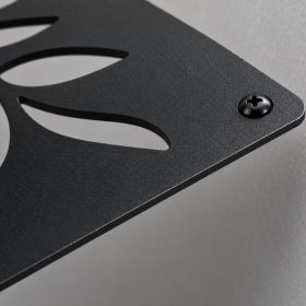 Close-up of black powder coated laser cut steel sign edge with mounting screw