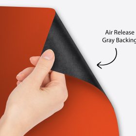 Hand peeling premium vinyl to show the air-release gray backing